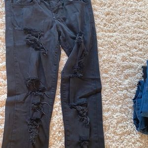 Black jeans with rips down leg